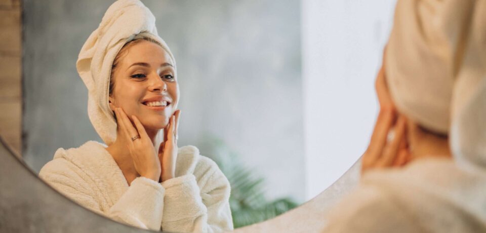 Woman at home applying cream mask Woman at home applying cream mask