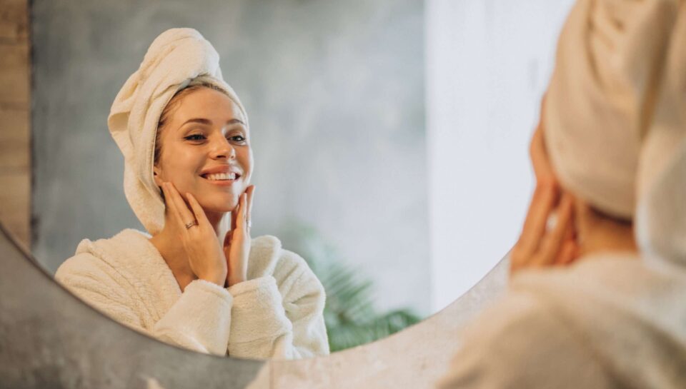 Woman at home applying cream mask